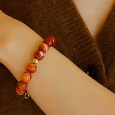 Transform your look with our Natural Red Onyx Beaded Bracelet! Hand-crafted from genuine, high-quality onyx beads, this bracelet radiates beauty and strength. The perfect accessory to elevate any outfit, this bracelet will inspire you to embrace your inner power and confidence. Metal: 18ct Recycled Gold Plated On Brass Gemstone:Red Onyx12mm Chain Length:180-200mm Weight: 23g Elegant Red Agate Beaded Bracelets, Elegant Red Carnelian Beaded Bracelets, Amber Agate Gemstone Beaded Bracelets, Elegant Red Agate Bracelets, Elegant Red Carnelian Bracelet, Red Agate Gemstone Beaded Bracelets, Elegant Amber Beaded Bracelets With 8mm Beads, Elegant Amber Bracelets With Polished Beads, Amber Beaded Bracelets With Round Beads