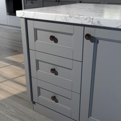 an image of a kitchen setting with marble counter tops and drawers on the island top