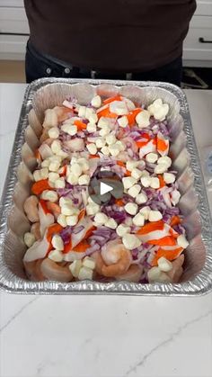 a pan filled with vegetables on top of a counter