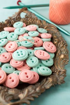 some pink and blue buttons are on a plate