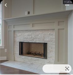 an empty fireplace in a living room with white walls and trimming on the mantle