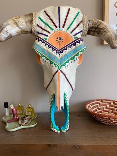 an animal's skull is sitting on top of a wooden table next to other items