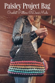 a woman holding a crocheted purse with the words, paisley project bag written on it