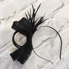 Lovely black fascinator, perfect for a wedding guest or bridesmaid headpiece. Created from black sinamay and trimmed with black biot feathers, with silver beads.   Mounted on a black metal headband. This design can also be made on a comb if required.  A beautiful addition to complete your outfit for a wedding, or day at the races  This design can be made in various colours to match your outfit. Please contact me for a custom order Evening Fascinator With Feather Trim, Adjustable Black Feather Headpiece, Adjustable Black Feathered Headpiece, Black Feathered Fascinator For Kentucky Derby, Black Headband For Kentucky Derby Wedding, Black Headband For Wedding Or Kentucky Derby, Black Headband For Wedding At Kentucky Derby, Black Wedding Headband For Kentucky Derby, Adjustable Black Fascinator For Races