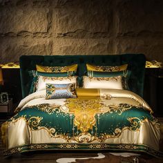 a green and gold bed with pillows on it