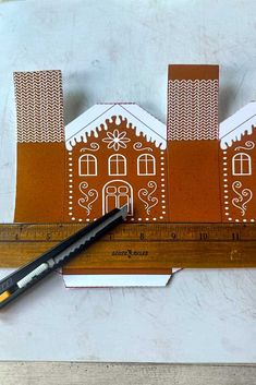 a ruler with some cut out houses on it