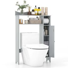 a white toilet sitting next to a gray cabinet