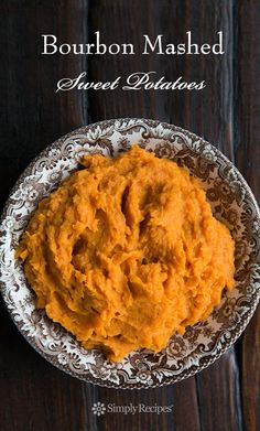 a bowl filled with mashed carrots on top of a wooden table