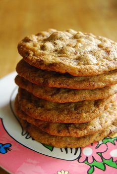 a stack of cookies sitting on top of a pink plate