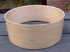 a wooden bowl sitting on top of a table