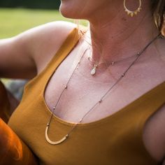 Simple is always stylish. Our Gemstone necklace has an exquisite moonstone gemstone pendant paired with a soft palate of mixed metals on a neutral, synthetic, super-strong cord. This delicate and durable necklace is fully adjustable to 18" with a decorative cinch closure to keep it tidy. sterling silver and 24k gold vermeil components lightweight - perfect for travel - dress it up or down artisan made in USA lifetime warranty Everyday Moonstone Necklaces, Everyday Moonstone Necklace, Soft Palate, Travel Dress, Gold Accent, Mixed Metals, Rainbow Moonstone, Gemstone Necklace, Gold Accents