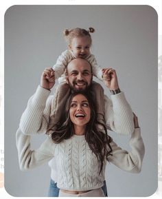 a man and woman holding a child on their shoulders, with the caption that reads dad