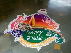 a colorful happy diwali design on the floor