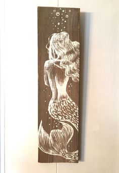 an image of a mermaid on a wooden plank with the words $ 99 added to it