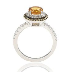 Suzy Levian Round-Cut Citrine, Yellow Sapphire and White Topaz Ring  This chic citrine, yellow sapphire and white topaz ring carries a message from designer Suzy Levian in the form of her signature "hidden diamond," set inside the shank. By creating jewelry that is beautiful inside and out, she hopes to empower women to discover their own inner strength, power and beauty.         Approx. 0.43"L x 0.43"W x 0.31"H; shank 0.08"W     Stamped .925     Sterling silver ring has as round-cut citrine sol Luxury Topaz Ring With Halo Design, Luxury Yellow Halo Jewelry, Elegant Yellow Halo Ring, Luxury Topaz Rings With Halo Setting, Elegant Citrine Topaz Ring With Halo Setting, Elegant Citrine Diamond Ring With Halo Setting, Elegant Citrine Jewelry With Halo Setting, Luxury Citrine Rings With Halo Setting, Elegant Topaz Halo Ring