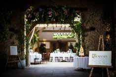 an entrance way to a restaurant with tables and chairs set up for formal function in the evening