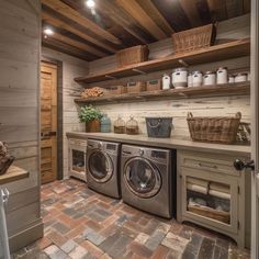 a washer and dryer in a laundry room with wooden shelves on the wall