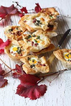 some food is sitting on a wire rack with leaves around it and one has an egg in the middle