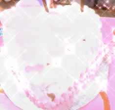 a white frosted cake sitting on top of a pink plate