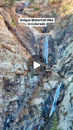 people are walking up and down the stairs near a waterfall