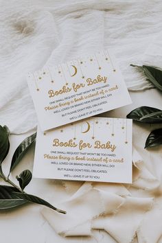 two white cards with gold foil stars and the words books for baby written on them