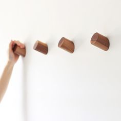 a person is placing wooden pieces on the wall