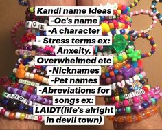 a stack of colorful bracelets with words written on them and an image of a person's hand