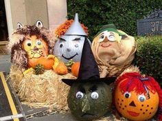 several pumpkins with faces on them are sitting in hay bales and decorated to look like witches