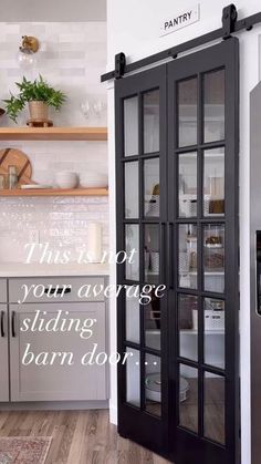 an image of a kitchen setting with the words, this is not your average sliding barn door