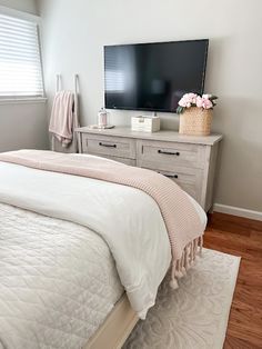 a bedroom with a large flat screen tv on the wall