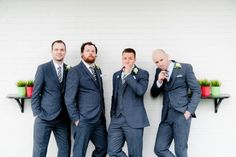 three men in suits and ties are standing next to each other with their hands on their chins