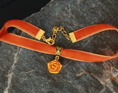 "Orange velvet ribbon choker with sculpted orange-yellow rose. Rose material is polymer clay Each petal of flower made by hand Dia flower about 15 mm/ 0.55 \" Length of choker is adjustable: 10-12 inches/ 25,4 - 30,5 cm 11-13 inches/ 28-33 cm 12-14 inches/ 30.5- 35.5 cm 13-15 inches/ 33-38 cm 14-16 inches/ 35.5 cm-40.6 cm 15-17 inches/ 38,1 cm- 43,2 cm 16-18 inches/ 40,6 cm- 45,7 cm 17-19 inches/ 43,2 cm- 48,2 cm Width of ribbon 10 mm / 0.4 inch If you need other length of necklace let me know a Orange Choker Jewelry For Gift, Elegant Yellow Choker As A Gift, Elegant Yellow Choker For Gifts, Handmade Orange Choker As Gift, Handmade Orange Choker For Gifts, Yellow Flower Necklace, Chunky Choker Necklace, Hufflepuff Aesthetic, Rose Choker