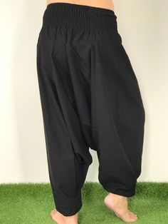 "These super soft rayon baggy unisex harem pants have the \"flow\", perfect of yoga or just a cool strolling. Comfort and character are what these pants are all about. They have the traditional sarong look & feel but a lot more practical when it comes to activity like yoga. As a bonus, they are convertible! Just pull them up and you get yourself a cute jumpsuit in a flash. Together with elastic cuff legs, you can wear them short or long. The pants have smock waist (wide bang elastic) with no Cotton Drop Crotch Harem Pants For Yoga, Baggy Ankle-length Harem Yoga Pants, Traditional Relaxed Fit Wide Leg Harem Pants, Traditional Wide Leg Harem Pants For Meditation, Traditional Harem Pants For Yoga, Traditional Harem Pants For Meditation, Baggy Drop Crotch Harem Pants For Yoga, Black Cotton Harem Yoga Pants, Traditional Relaxed Fit Harem Pants For Yoga