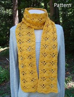 a woman wearing a yellow crocheted scarf