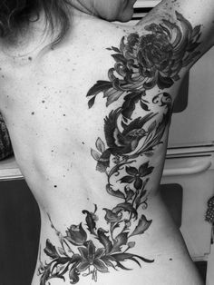 a woman's back with flowers on it