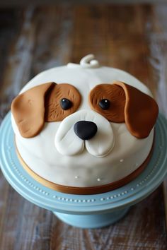 a cake decorated with a dog's face on top of a blue platter