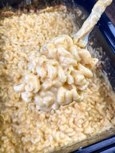 a spoon full of macaroni and cheese being stirred