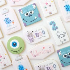 some very cute looking magnets on a white surface with cartoon characters and words written on them