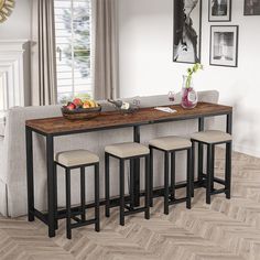 a kitchen table with four stools in front of it