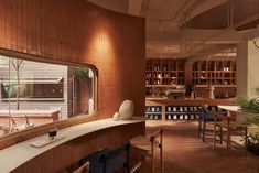 the interior of a restaurant with wooden walls and flooring, along with tables and chairs