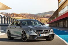 the mercedes c - class coupe is parked in front of a building