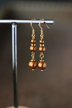 Unique geometric earrings with finest quality European crystal red copper color pearl beads (4,6 and 8 mm), gold tone stainless steel beads   separators and gold tone stainless steel earring hooks. Earring hooks are from nickel free and lead free metal. *The total lenght of earrings is about 47 mm including earring rings. Other earrings of my shop you can see here: https://www.etsy.com/shop/NaTavelli?section_id=13757927 Thank you for visit! Elegant Brown Metal Beaded Earrings, Elegant Copper Teardrop Earrings, Brown Pearl Drop Earrings As Gift, Elegant Nickel-free Copper Beaded Earrings, Elegant Copper Beaded Nickel-free Earrings, Brown Pearl Drop Earrings For Gift, Elegant Copper Teardrop Earrings Gift, Elegant Gold Beaded Hypoallergenic Earrings, Elegant Gold Hypoallergenic Beaded Earrings