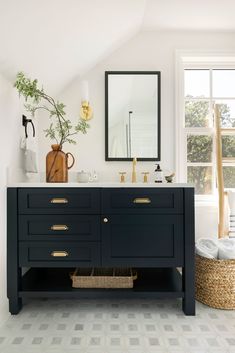 a bathroom with white walls and black vanity