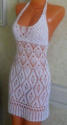 a mannequin wearing a white crochet dress