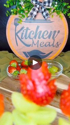 the kitchen meats sign is on display in front of some vegetables and fruit bowls