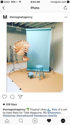 an instagram photo booth with blue backdrop and stools in the foreground, as seen on instagram