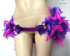 a mannequin with purple and pink feathers on it