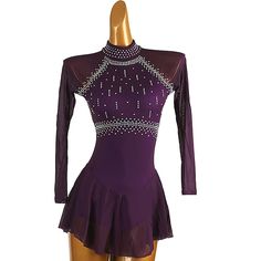 a female figure in a purple leotard suit with beading on the neck