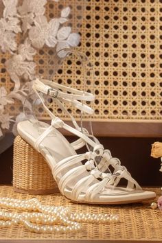 Monza White Strappy Sandals with Basket Weave Block Heel from Oasis Society, featuring a stylish strappy design and unique basket weave block heel, ideal for a bridal look. White Strappy Heels For Vacation, Summer Vacation Heels With Strappy Design, Vacation Strappy Heels With Wrapped Heel, Summer Vacation Strappy Heels, Spring Party Heels Made Of Straw, Spring Party Straw Heels, Straw Ankle Strap Heels For Party, Strappy Heel Strap Heels For Vacation, Spring Block Heels With Braided Straps