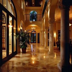 a large foyer with columns and lights